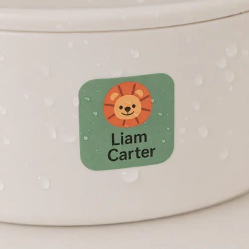 A water-resistant name label on a container covered in water droplets